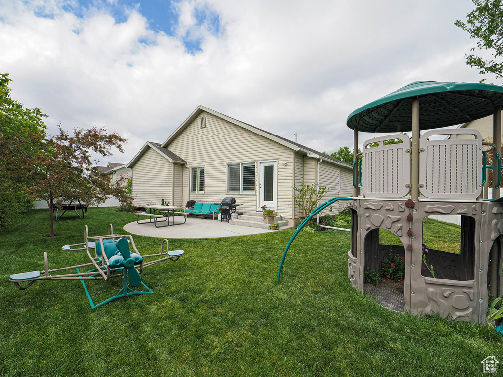 Back of house featuring a patio and a lawn