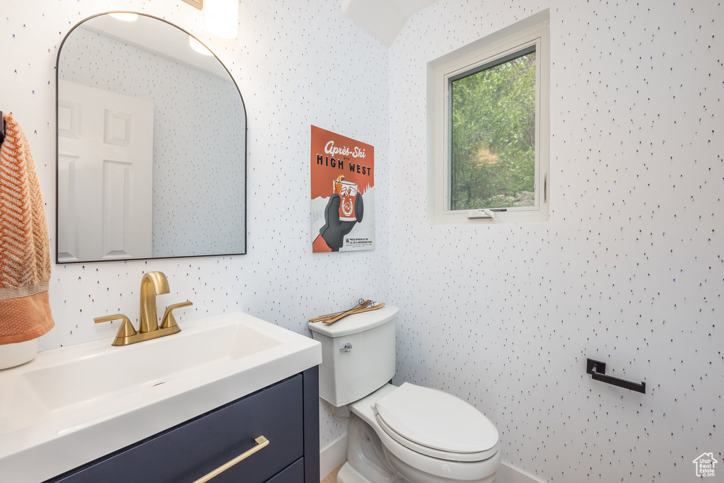 Half bathroom featuring toilet and vanity