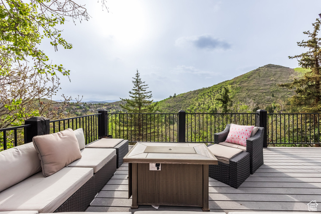 Wooden deck with an outdoor hangout area and a mountain view