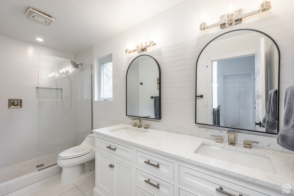 Full bath with toilet, walk in shower, double vanity, tile patterned floors, and recessed lighting