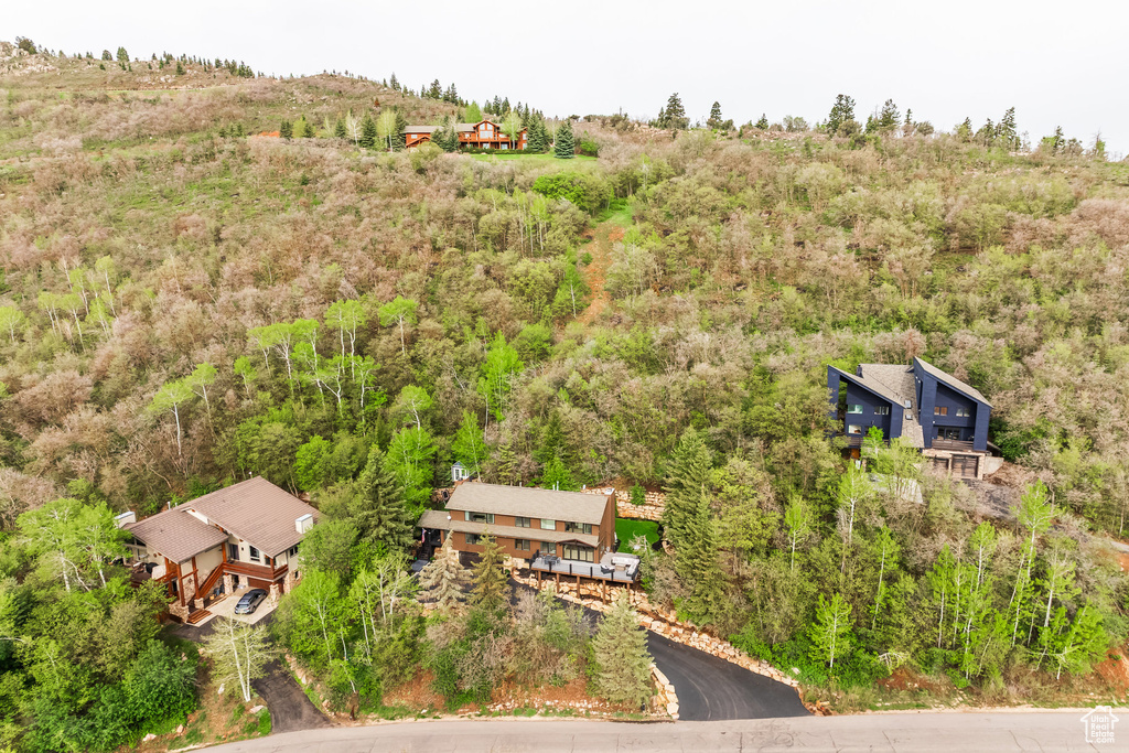 View from above of property featuring a heavily wooded area