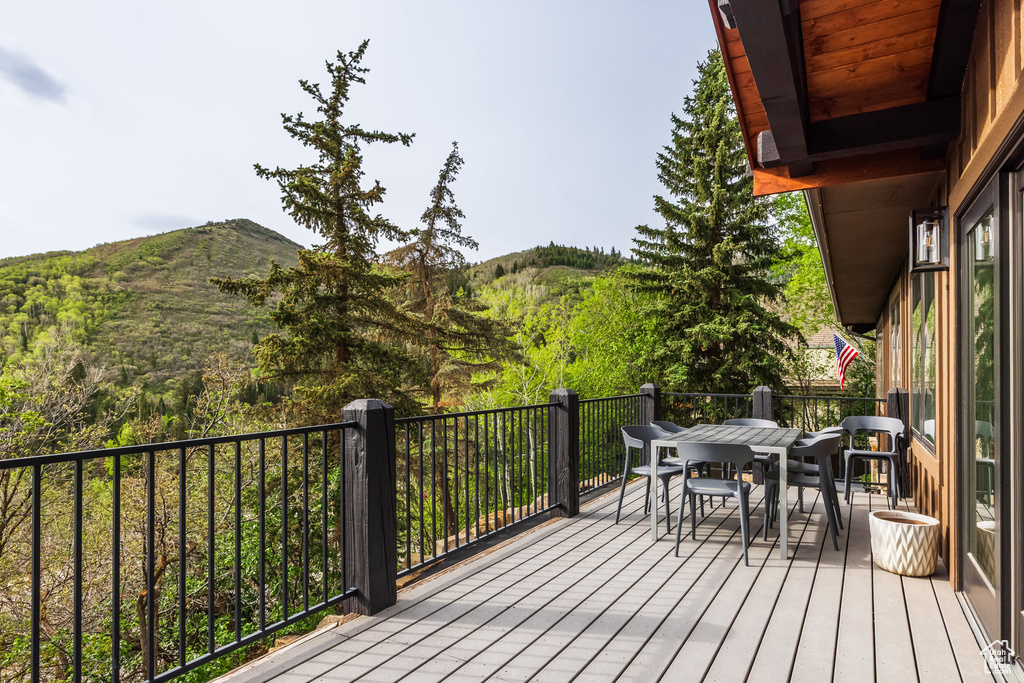 Wooden terrace with a mountain view and outdoor dining space