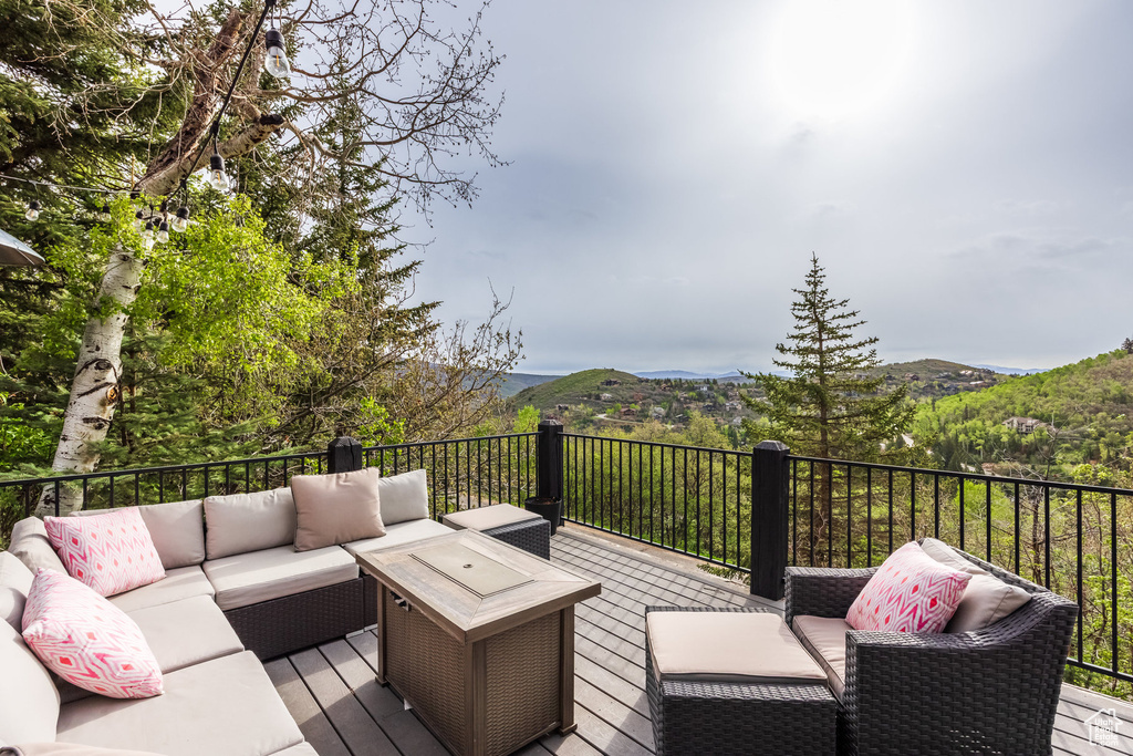 Deck with an outdoor hangout area and a mountain view