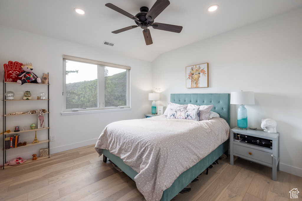 Bedroom featuring wood finished floors, baseboards, recessed lighting, and a ceiling fan