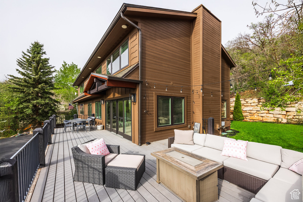 Wooden deck with an outdoor hangout area and outdoor dining space