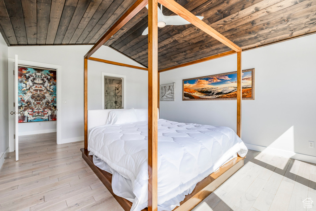 Bedroom with wood ceiling, light wood finished floors, and baseboards