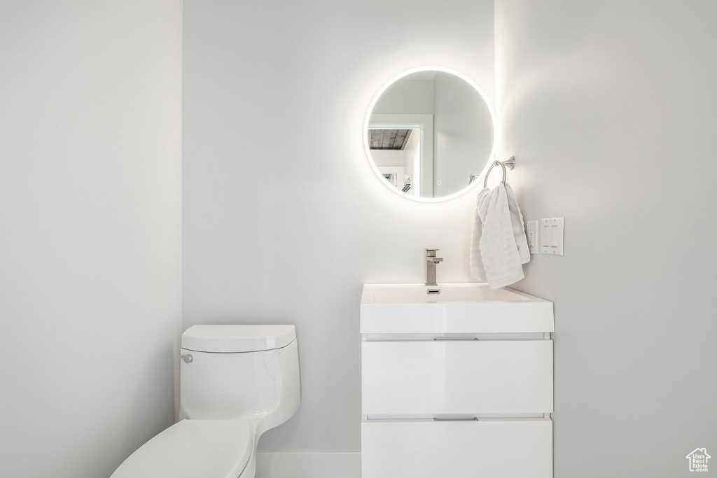 Half bath featuring toilet and vanity