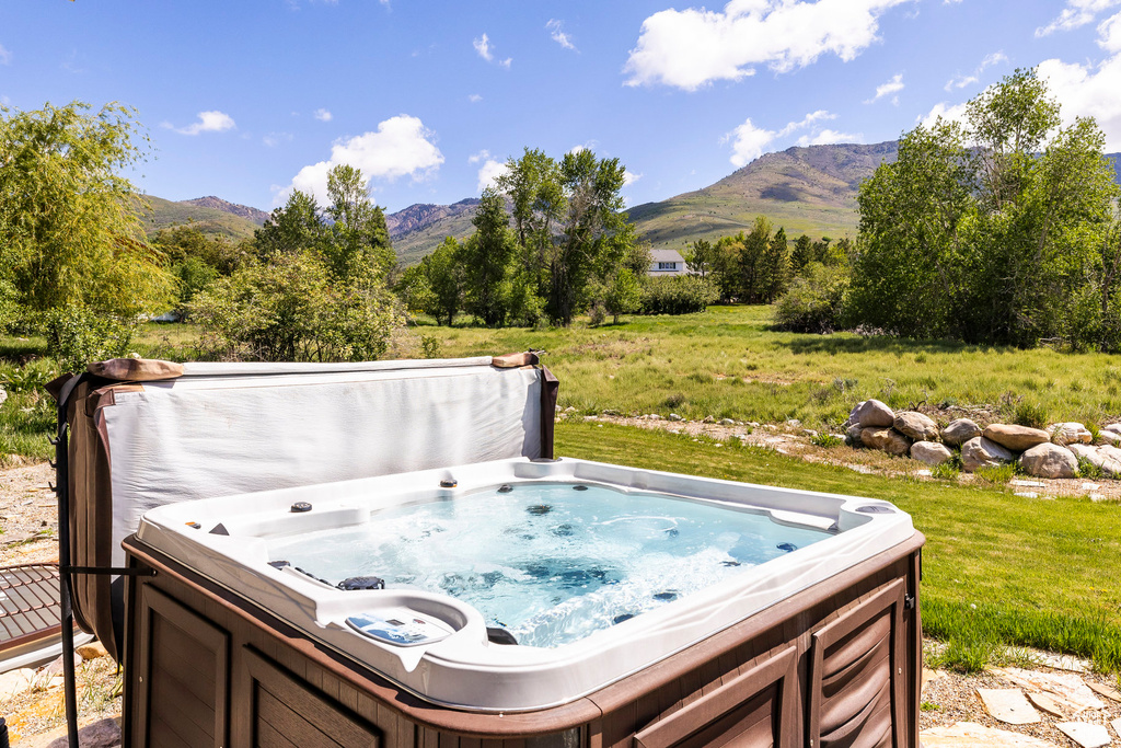 View of patio featuring a mountain view and a hot tub