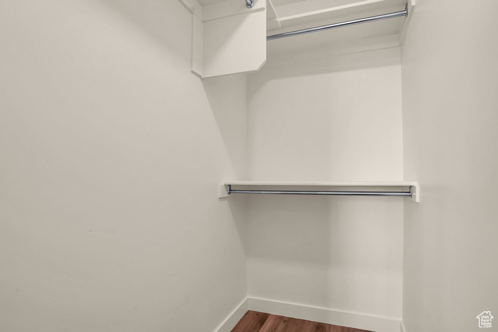 Walk in closet with wood finished floors