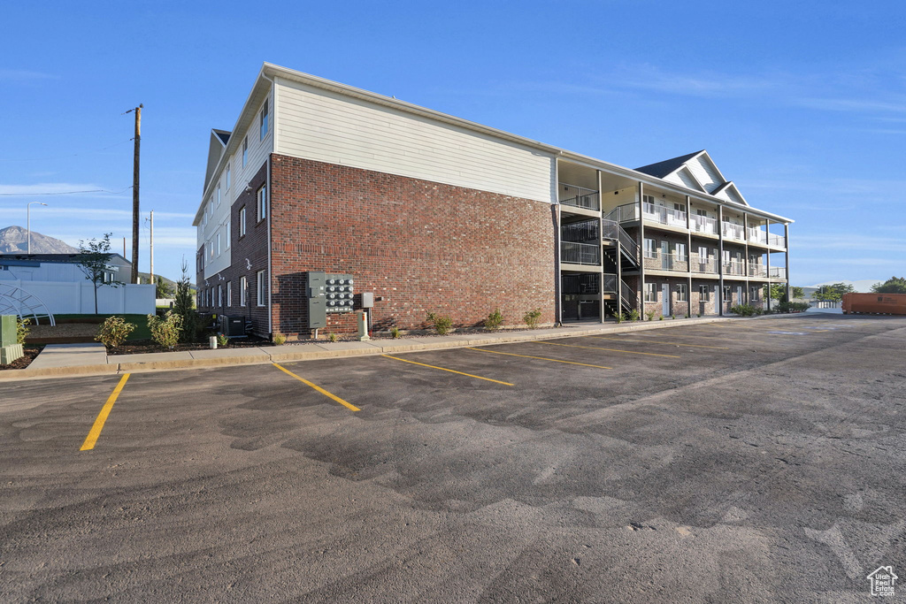 View of property with uncovered parking