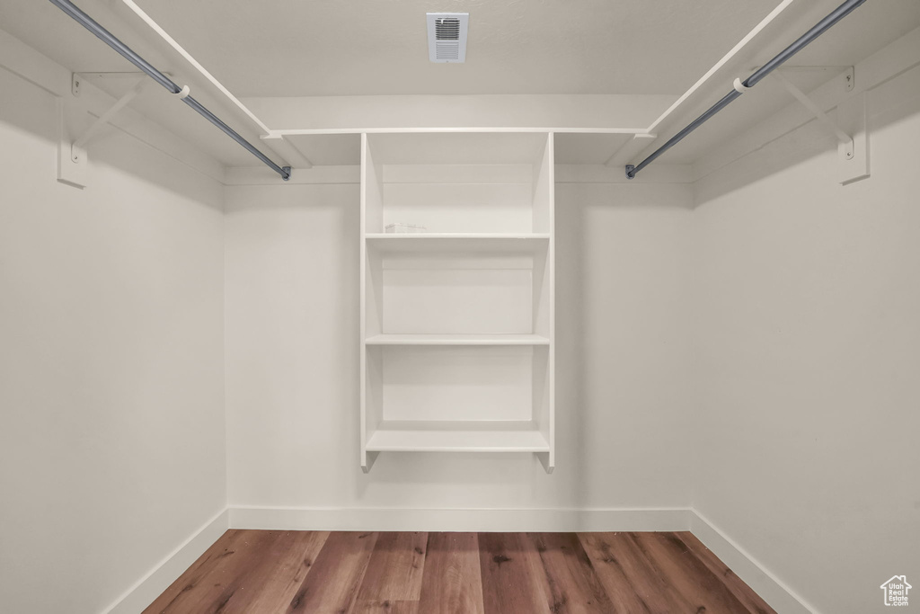 Walk in closet featuring wood finished floors