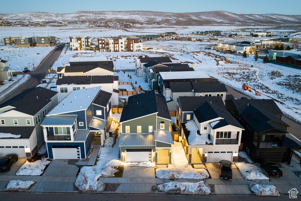 Snowy aerial view with a residential view and a mountain view