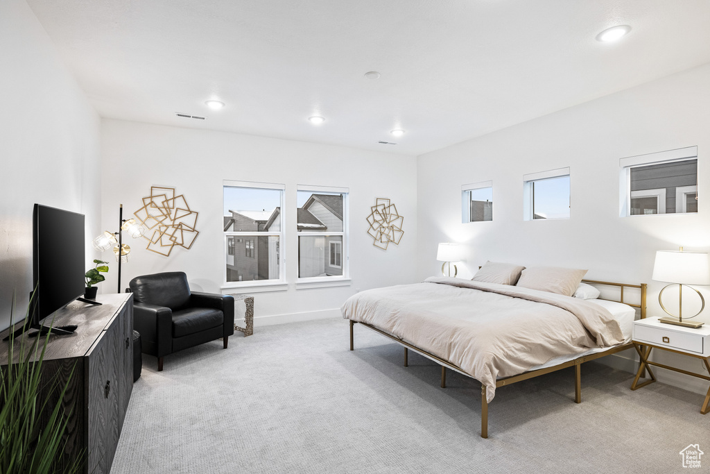 Bedroom featuring light colored carpet, recessed lighting, and baseboards