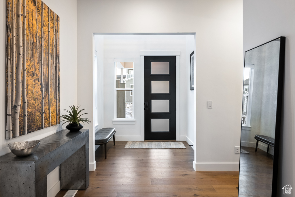 Foyer entrance featuring wood finished floors and baseboards
