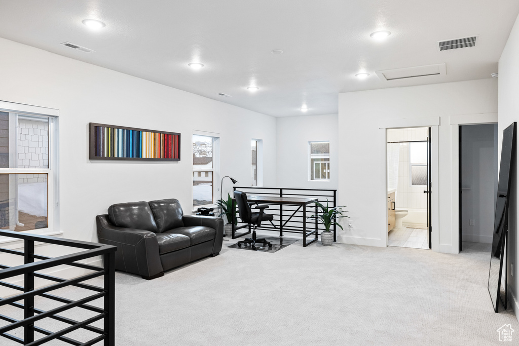 Living room featuring light colored carpet, attic access, baseboards, and recessed lighting
