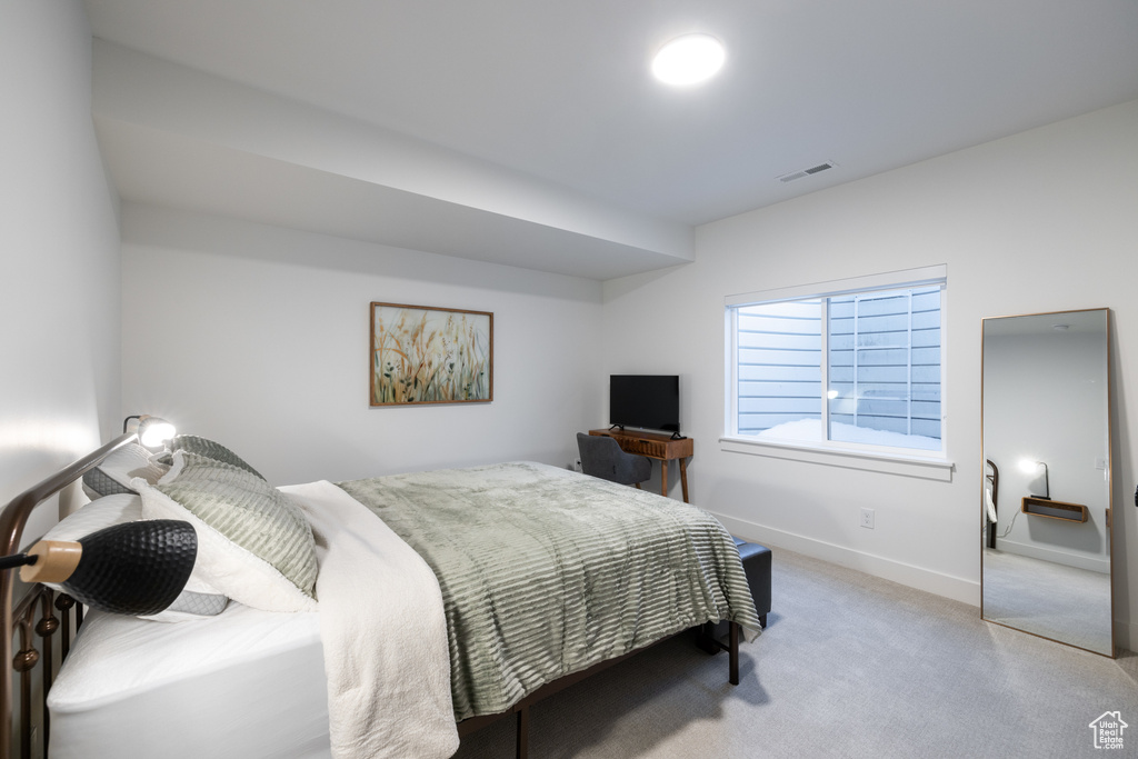 Bedroom featuring carpet flooring and baseboards