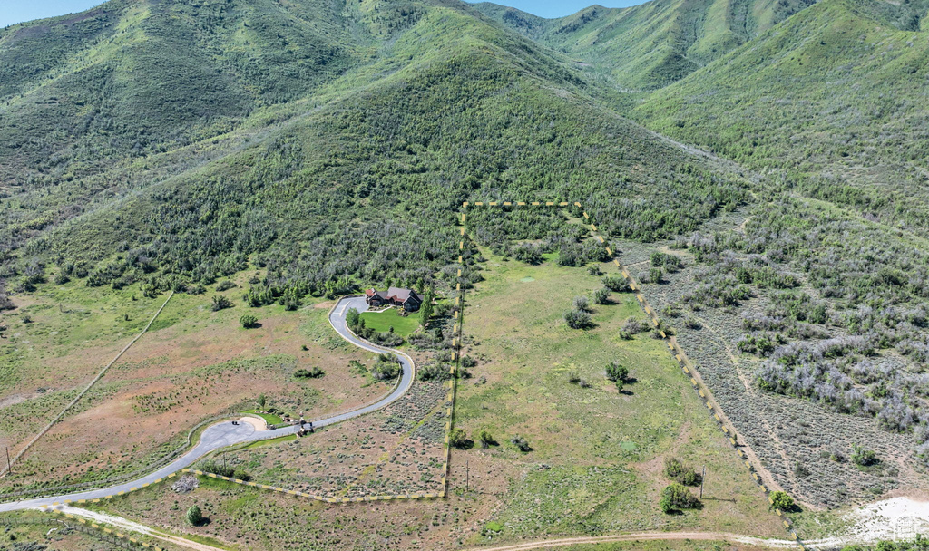 Aerial view of property's location with a mountain backdrop