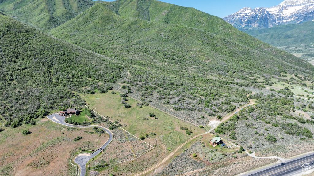 Aerial view of property and surrounding area with mountains