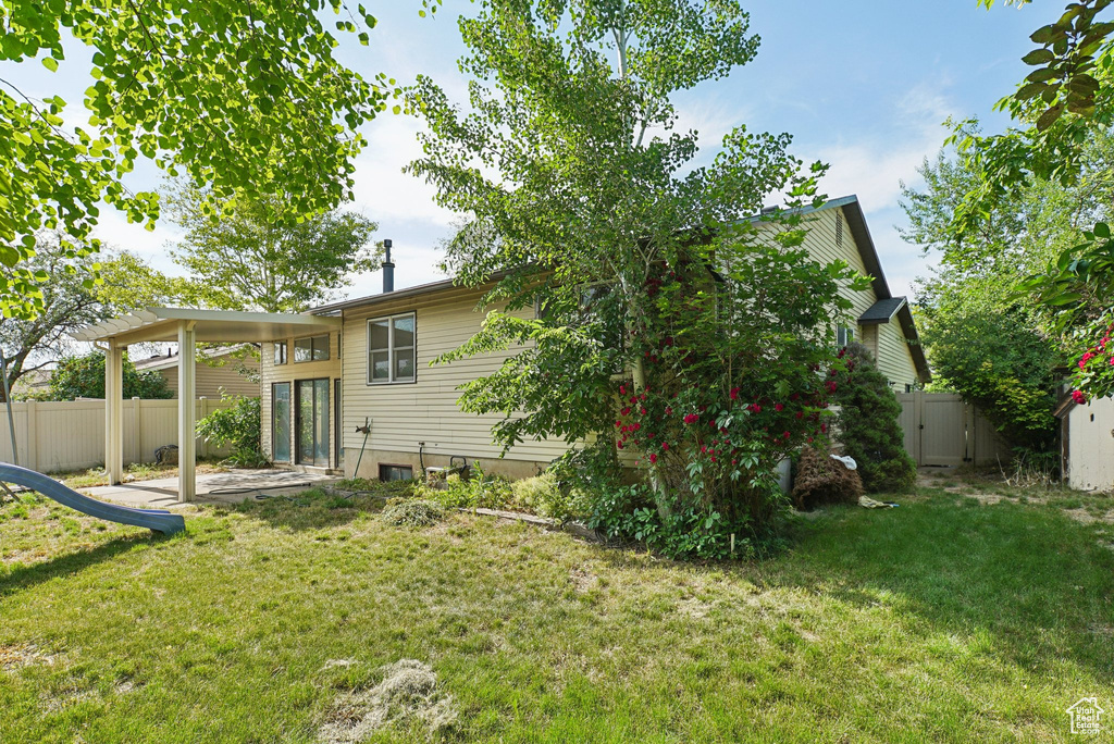 Rear view of house featuring a patio area