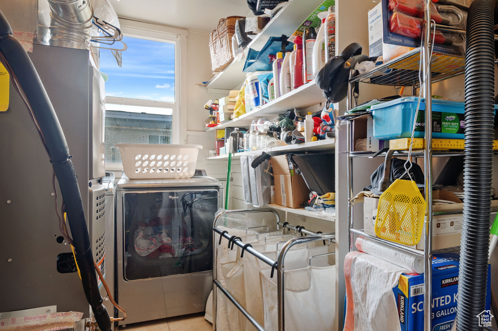 Laundry room featuring washer and clothes dryer and tile patterned floors