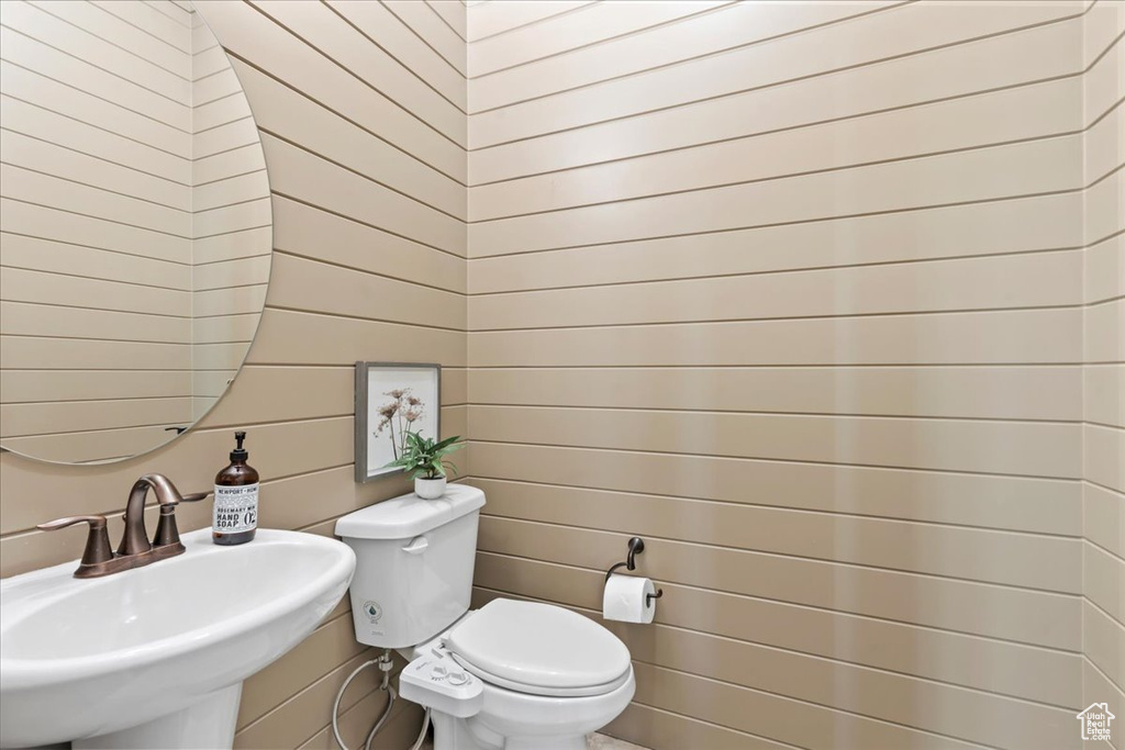 Half bathroom featuring a sink and toilet