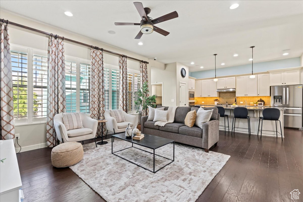 Living area featuring ceiling fan, dark wood finished floors, recessed lighting, and baseboards