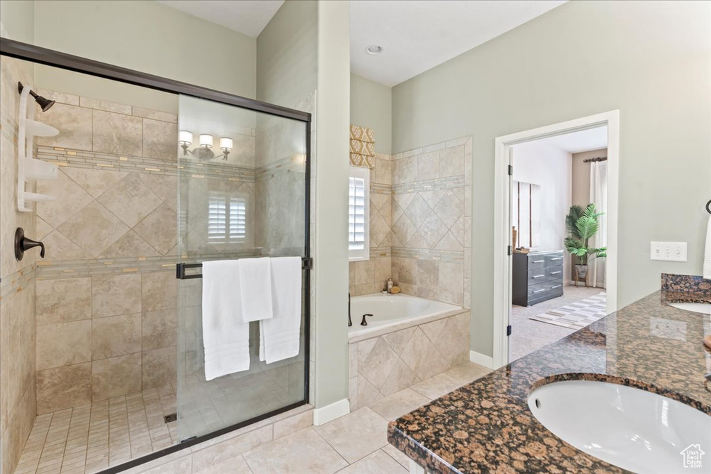 Full bath featuring a bath, a shower stall, vanity, and tile patterned flooring
