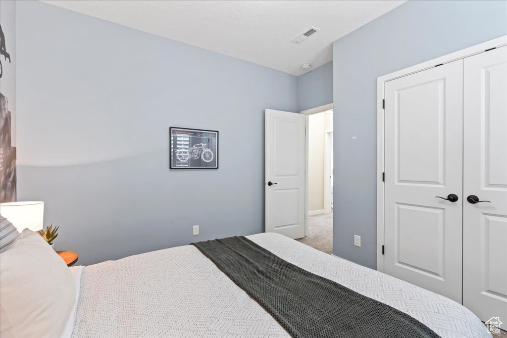 Bedroom featuring a closet and carpet flooring