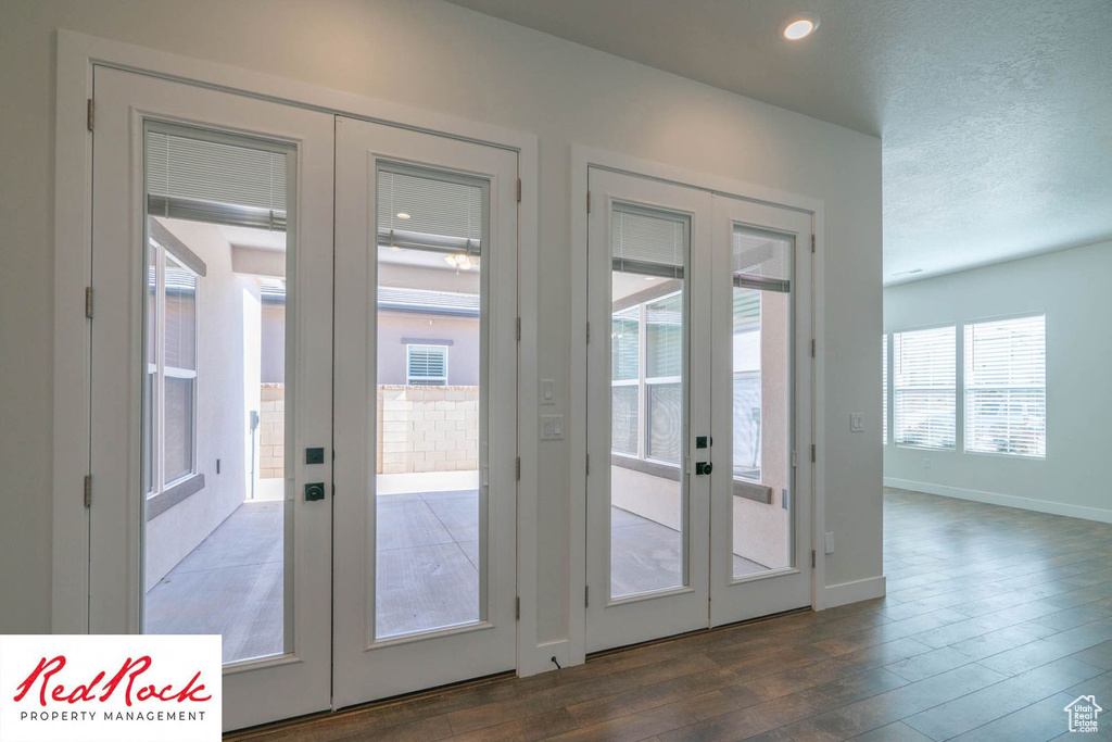 Entryway with french doors, wood-type flooring, baseboards, a textured ceiling, and recessed lighting