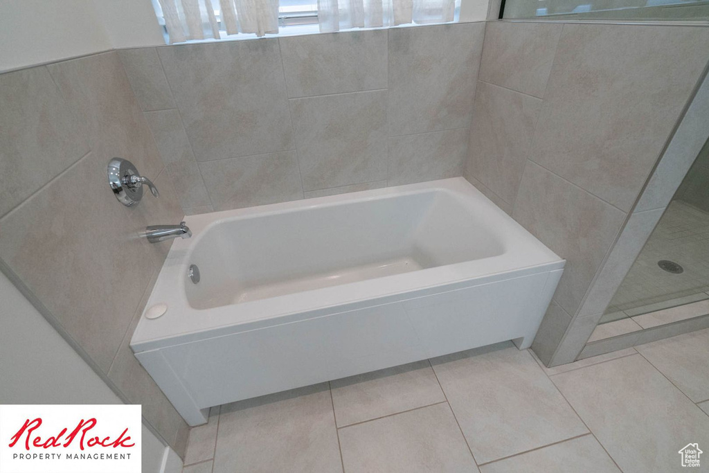 Full bath featuring a tub to relax in, a shower, and tile patterned flooring