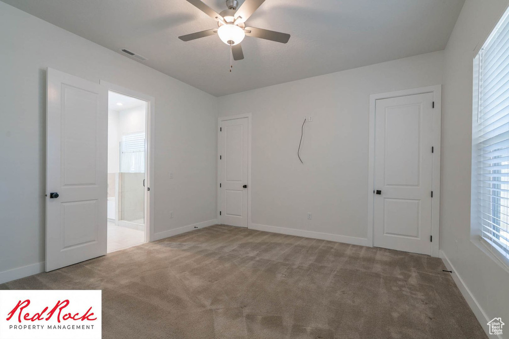 Unfurnished bedroom with carpet flooring, baseboards, and ceiling fan