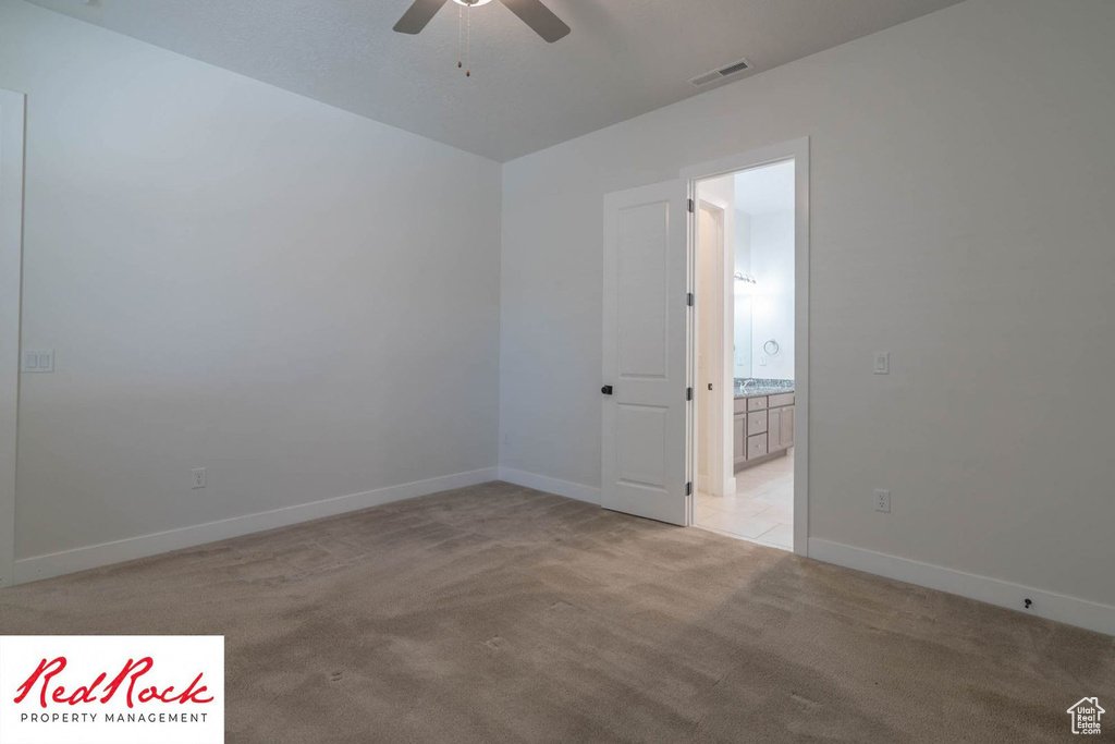Unfurnished room with ceiling fan, light carpet, and baseboards