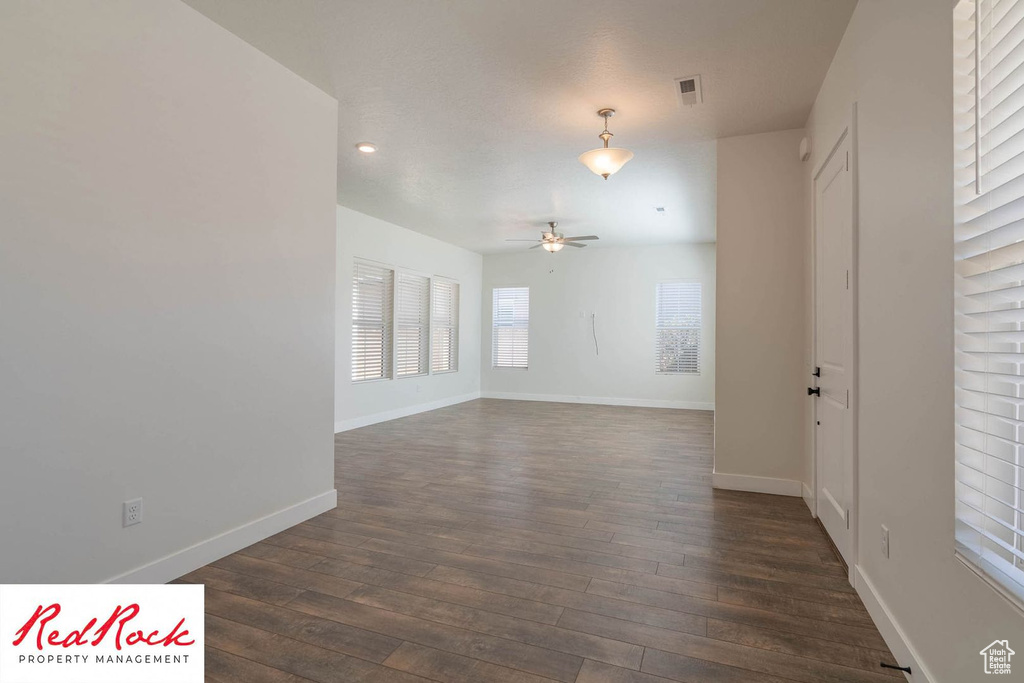 Spare room featuring a ceiling fan, dark wood-style flooring, baseboards, and recessed lighting