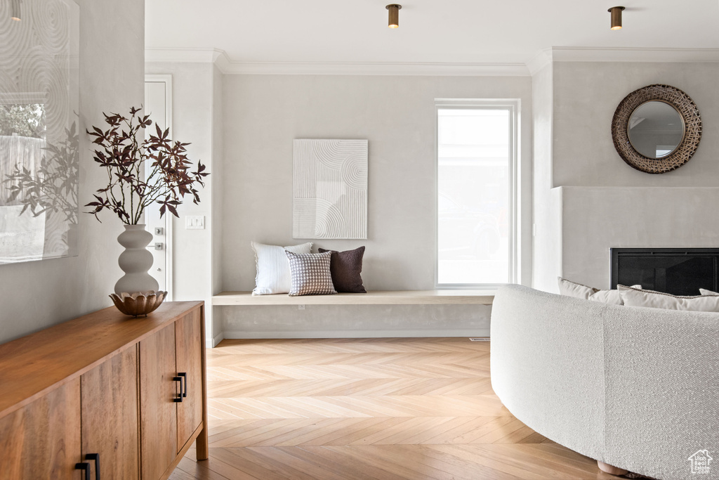Interior space with crown molding and a glass covered fireplace
