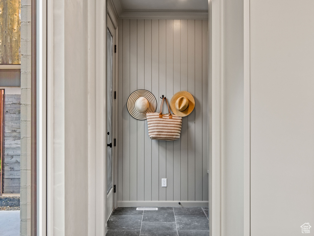 Hallway featuring baseboards and crown molding