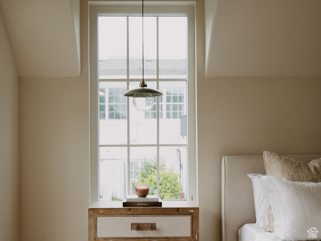 Bedroom with ornamental molding and baseboards