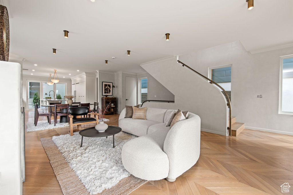Living area featuring crown molding, recessed lighting, and baseboards