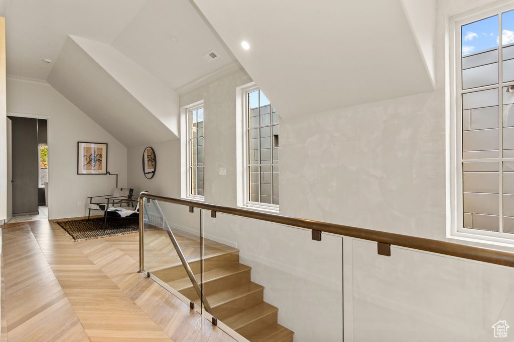 Stairs with baseboards and lofted ceiling