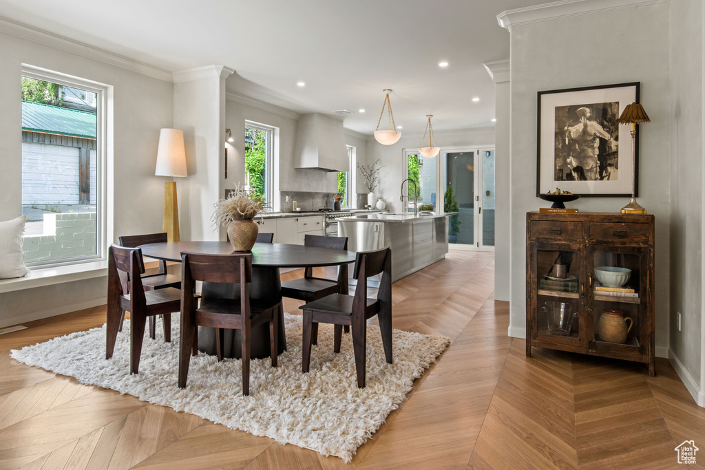 Dining room featuring healthy amount of natural light, crown molding, recessed lighting, and baseboards