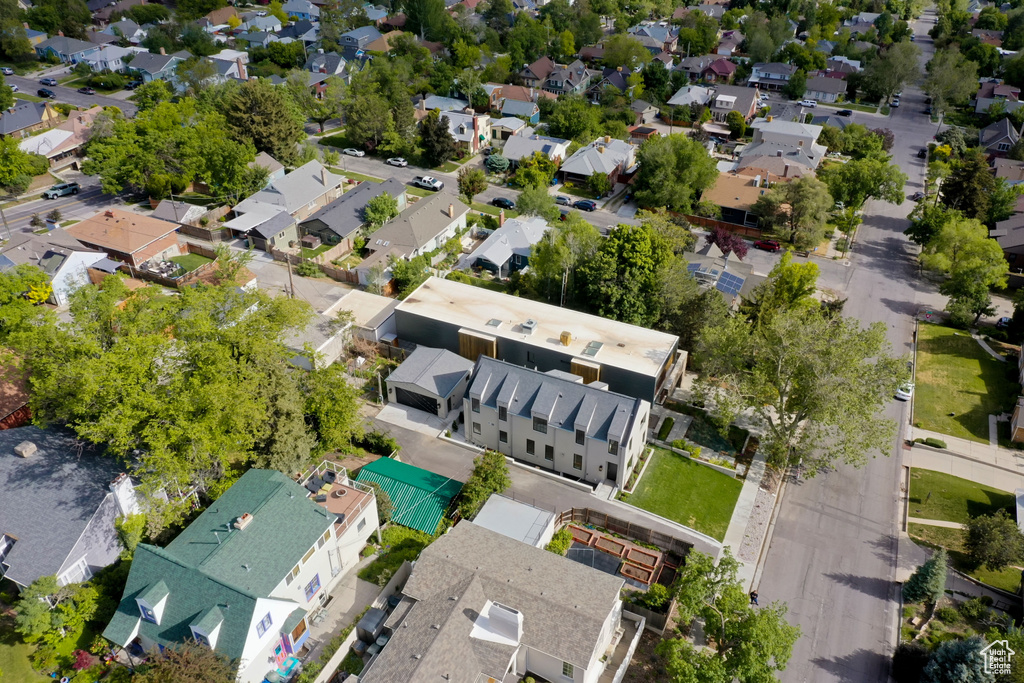 Aerial view of property and surrounding area with nearby suburban area