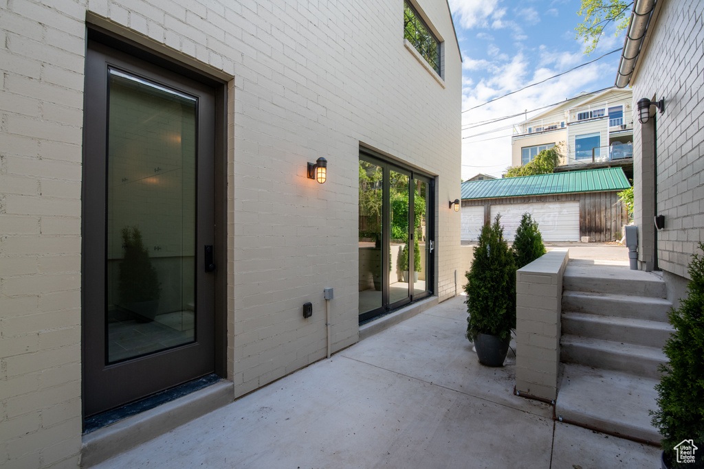 View of exterior entry featuring a patio area