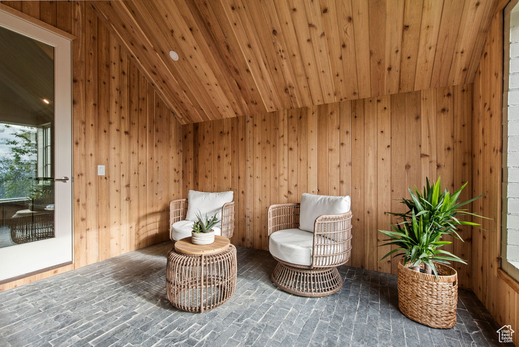 Sitting room with wood walls and lofted ceiling