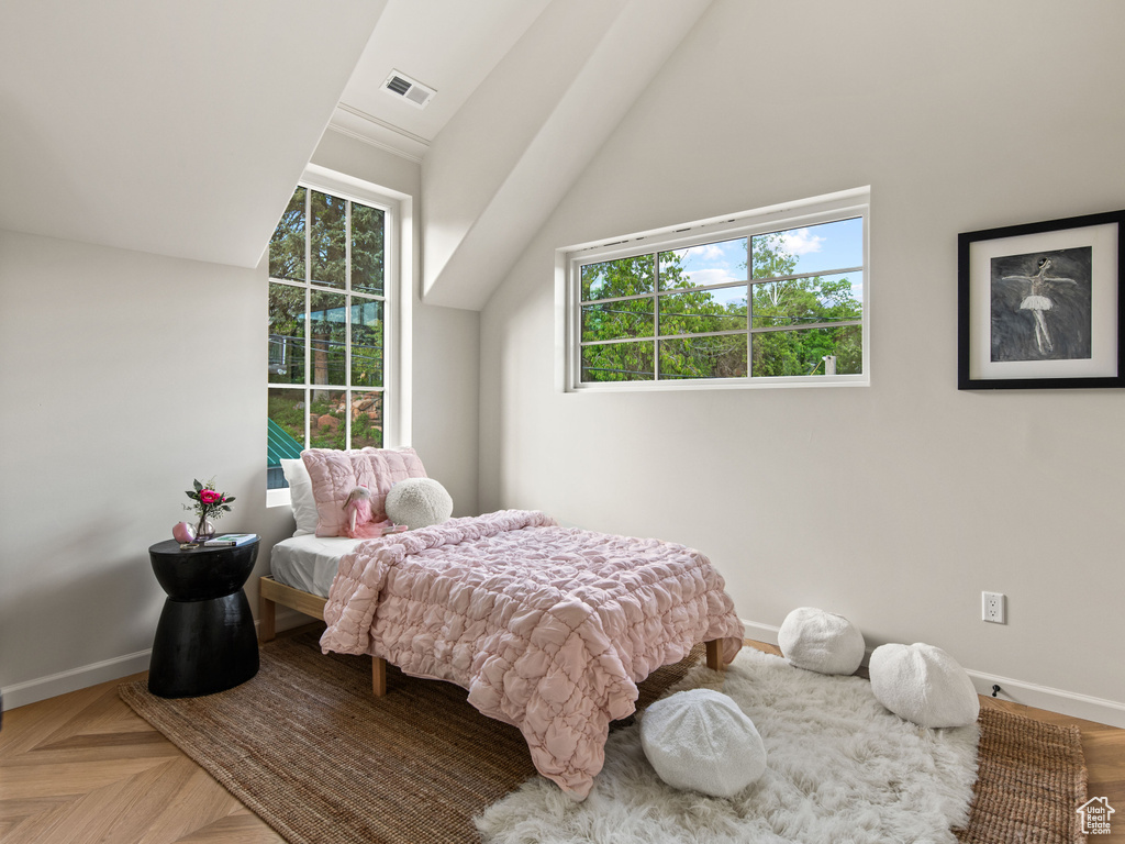 Bedroom featuring baseboards and vaulted ceiling