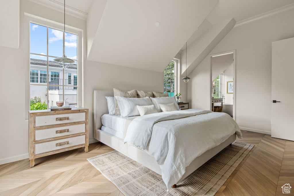 Bedroom with multiple windows, crown molding, and baseboards