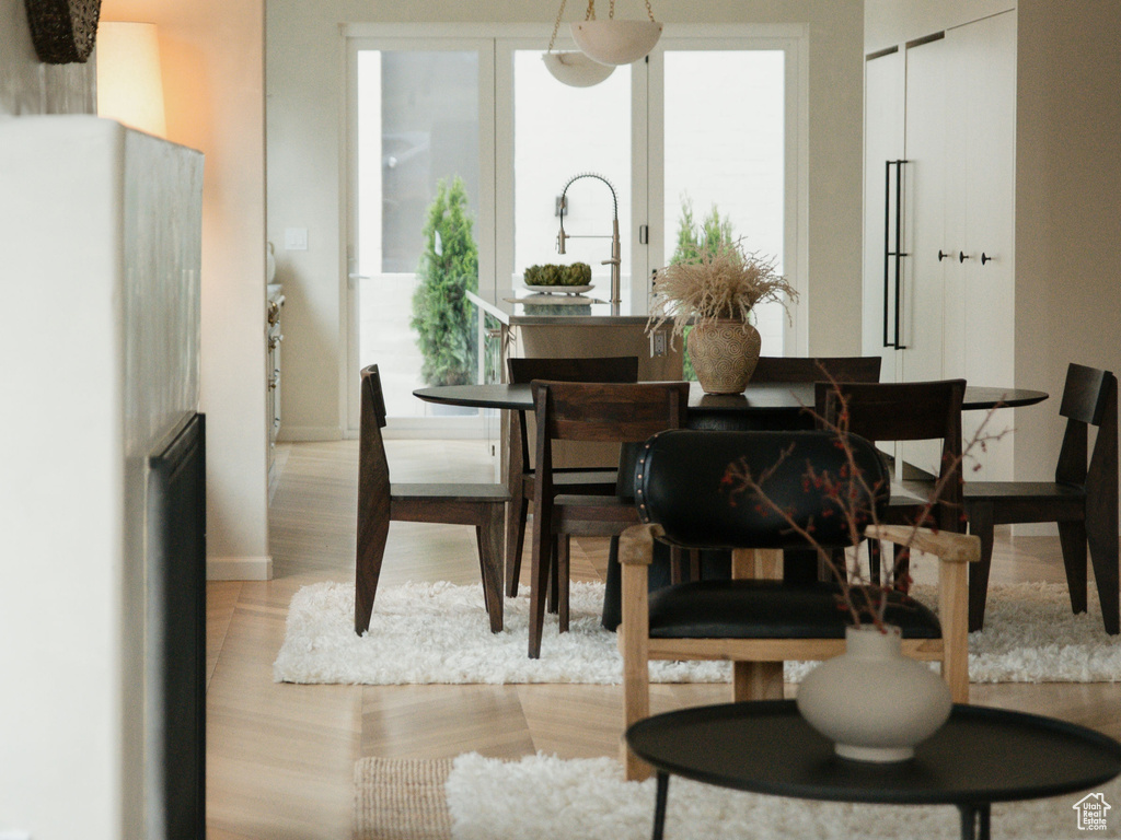 Living room featuring crown molding, baseboards, and light wood finished floors