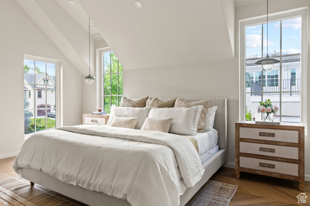Bedroom featuring access to outside, baseboards, and vaulted ceiling