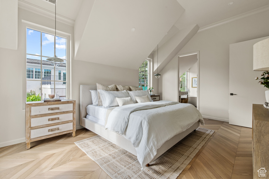Bedroom featuring baseboards, ornamental molding, and vaulted ceiling
