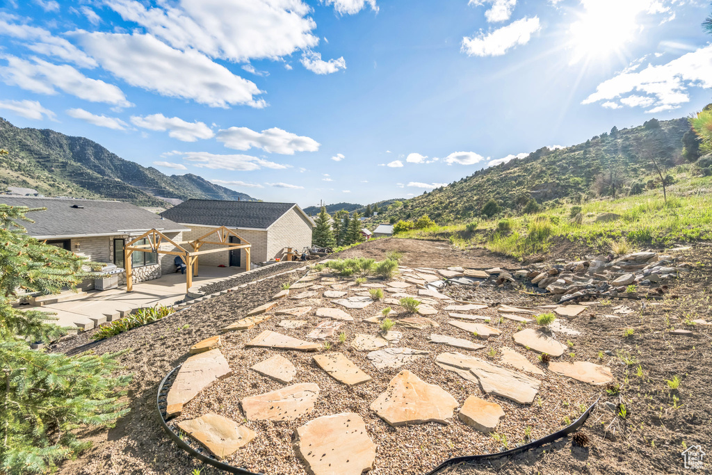 View of yard with a mountain view and a patio area