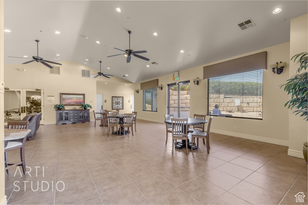 Dining area with ceiling fan, light tile patterned floors, recessed lighting, and high vaulted ceiling