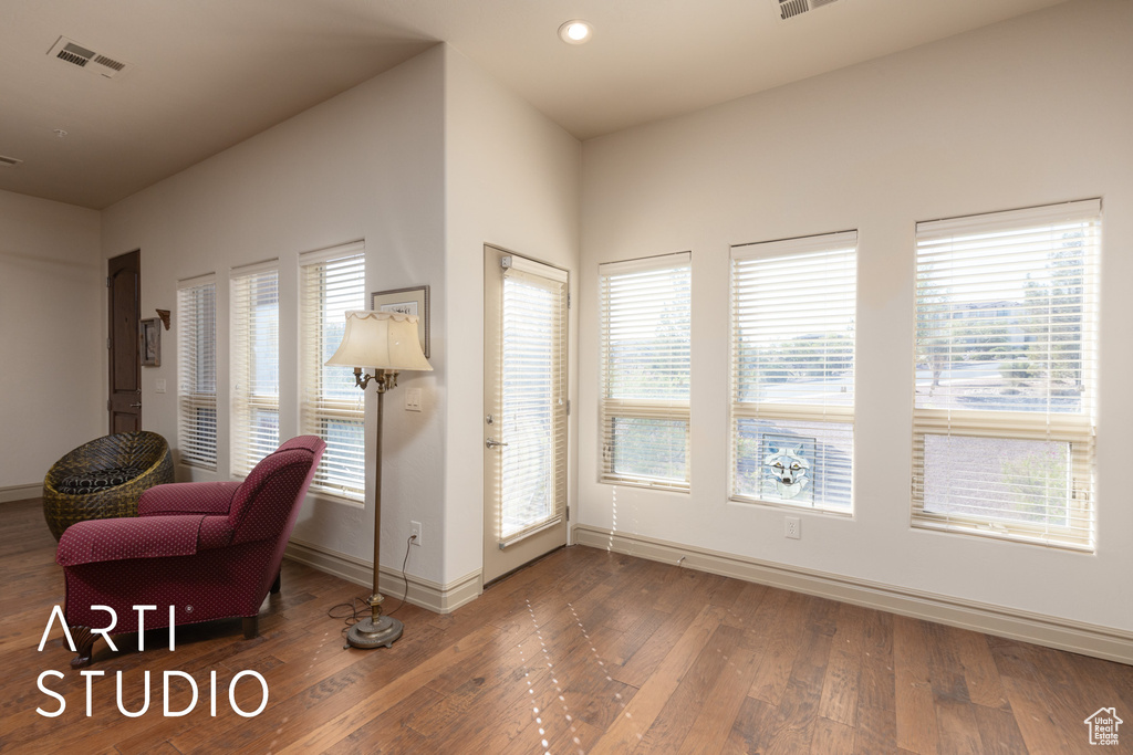 Sitting room featuring baseboards, hardwood / wood-style floors, and recessed lighting